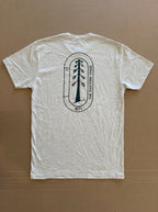 White t-shirt with a black logo on a brown background