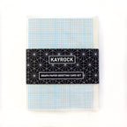 Set of blue grid greeting cards in clear sleeves, wrapped in a black band reading Kayrock Graph Paper Greeting Card Set